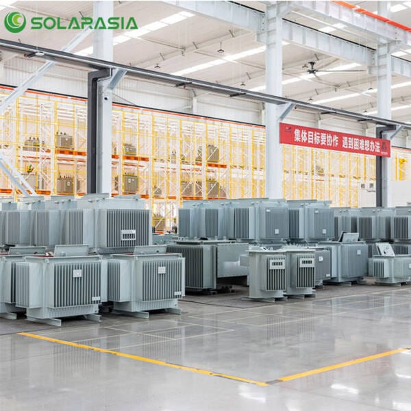 Skilled technicians carefully assembling or testing a transformer core or windings on the production line.