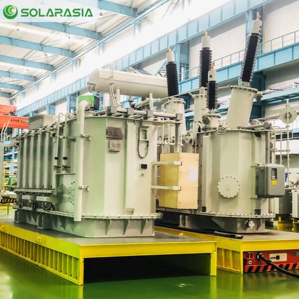 Rows of 50kV oil-immersed transformer units in various stages of assembly inside a modern, organized factory.