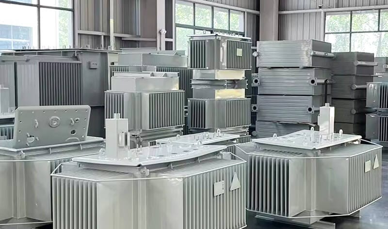 Inside our transformer manufacturing factory showing skilled technicians performing final checks on a oil immersed transformer before shipment.