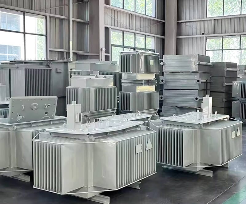 Inside our transformer manufacturing factory showing skilled technicians performing final checks on a oil immersed transformer before shipment.