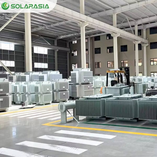 Wide shot of our transformer plant factory floor with multiple units, including 1250kVA oil immersed transformers, ready for final testing and dispatch.