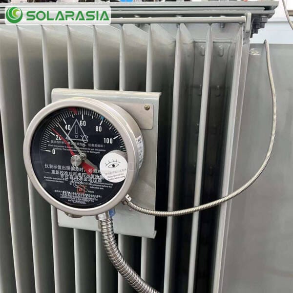 Detailed close-up shot of the control cabinet, gauges (oil level, temperature), and valves on a 1600kVA oil immersed transformer.