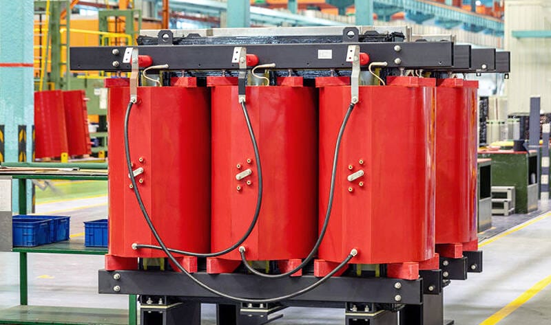 Front-facing image of the 100KVA Dry Type Transformer displaying terminals and control panels.