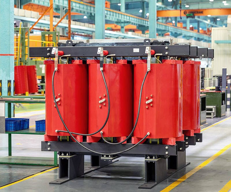 Front-facing image of the 100KVA Dry Type Transformer displaying terminals and control panels.