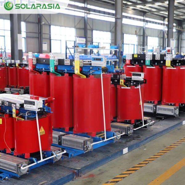 Three-quarter rear perspective of a 50KVA Dry Type Transformer in a factory setting, showcasing its overall build quality and internal component layout.