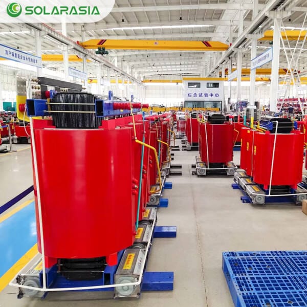 Wide-angle shot inside a modern factory producing electrical transformers, showing assembly lines for units including the 1000KVA Dry Type Transformer.