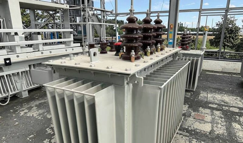 A oil immersed transformer operating reliably within an industrial power distribution substation.