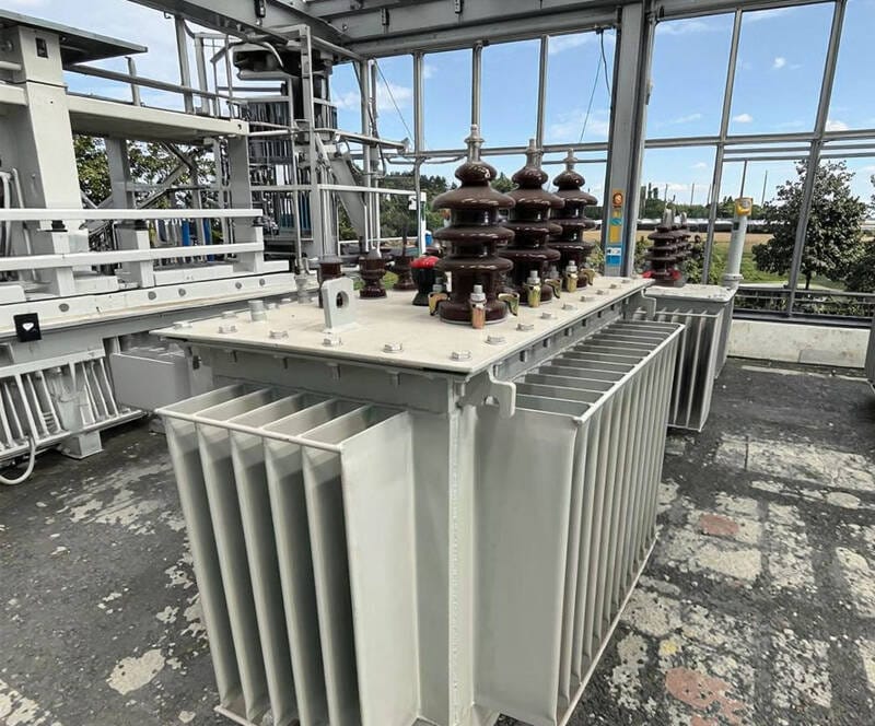 A oil immersed transformer operating reliably within an industrial power distribution substation.