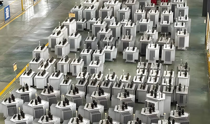 Wide-angle shot of a 200KVA oil immersed transformer installed in a factory environment.