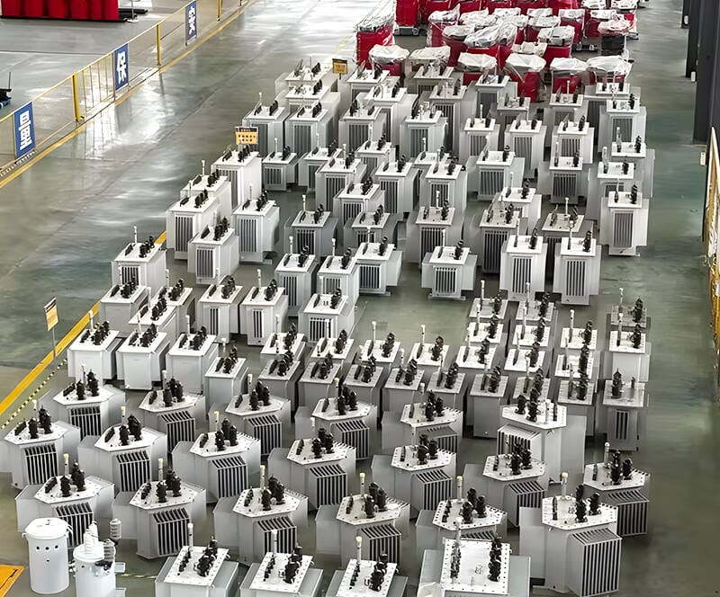 Wide-angle shot of a 200KVA oil immersed transformer installed in a factory environment.