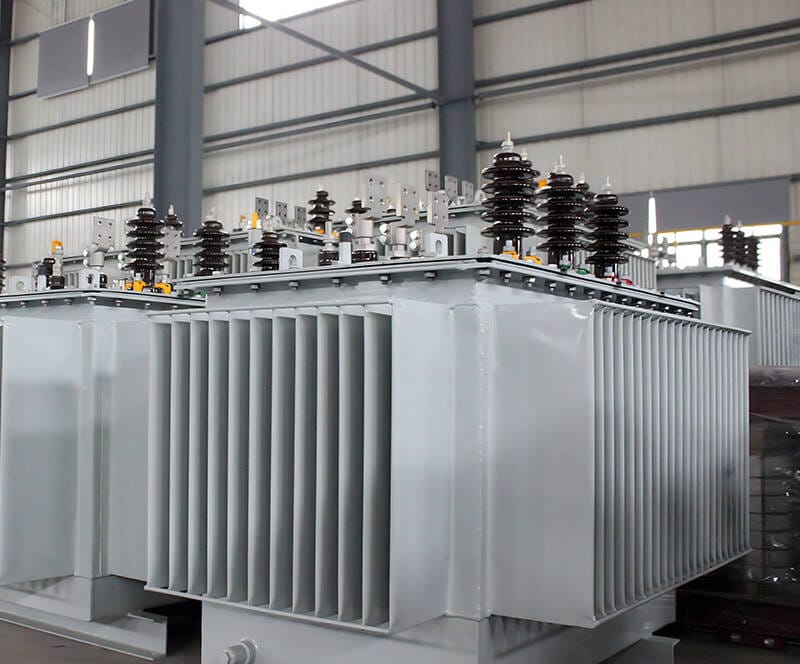 Inside view of a modern factory where skilled technicians are assembling a 30 kva oil immersed transformer.