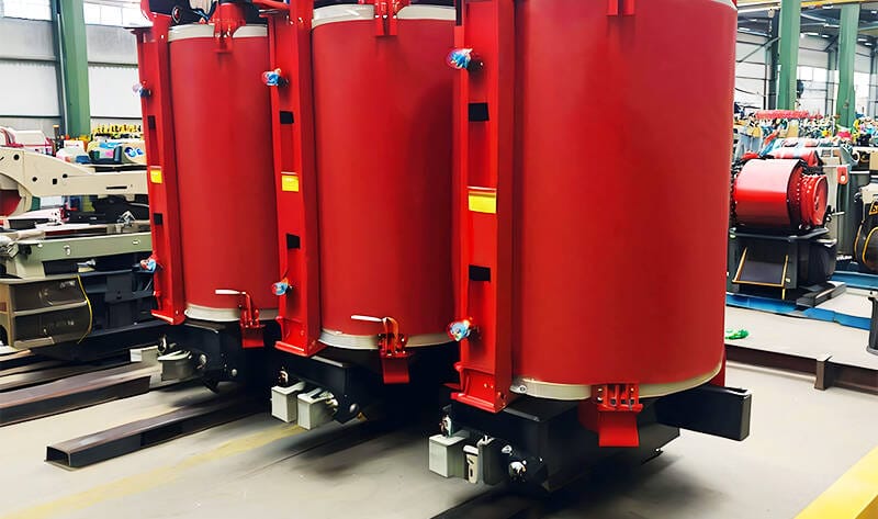 Factory production of SCB12 10KV cast resin dry transformer showing coil casting and core assembly process