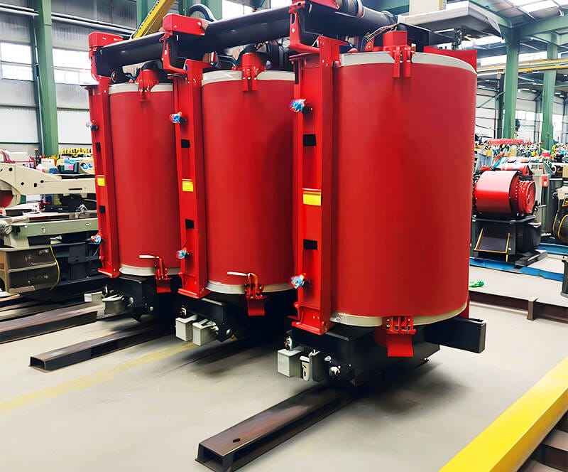 Factory production of SCB12 10KV cast resin dry transformer showing coil casting and core assembly process