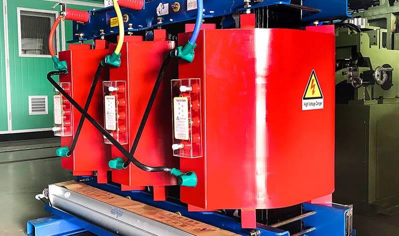 Finished SCB12 10KV cast resin dry type transformers lined up in factory workshop for inspection and delivery