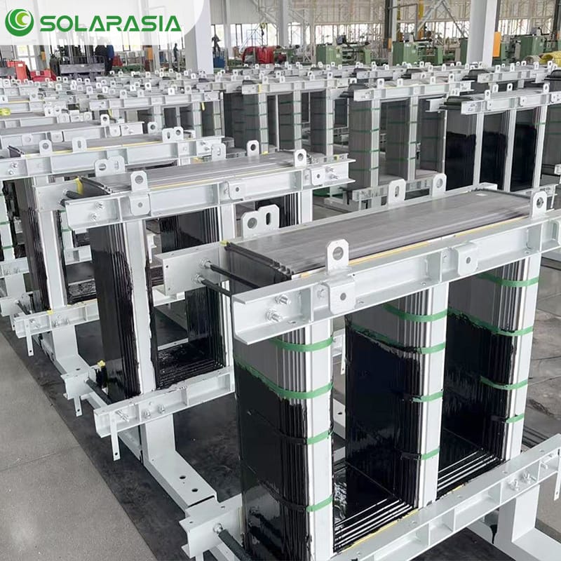 Technicians assembling and inspecting oil type transformers within a high-standard workshop.